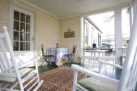 View of porch with rocking chairs.